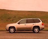 AUT 15 RK0558 03
2002 GMC Envoy Champagne Profile View On Pavement By Grass Hill Filtered