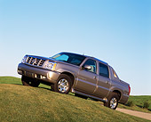 AUT 15 RK0572 01
2002 Cadillac Escalade EXT Silver 3/4 Front View On Grass Hill Blue Sky