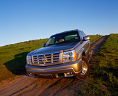 AUT 15 RK0575 01
2002 Cadillac Escalade EXT Silver 3/4 Front View On Dirt Hill Blue Sky