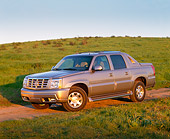 AUT 15 RK0576 01
2002 Cadillac Escalade EXT Silver Sand 3/4 Side View On Grass Hill Blue Sky