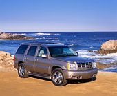 AUT 15 RK0598 10
2002 Cadillac Escalade Canepa Design LE Pewter 3/4 Front View On Sand By Ocean