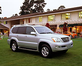 AUT 15 RK0606 02
2003 Lexus GX 470 Silver 3/4 Front View On Grass By Building At Dusk