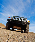 AUT 15 RK0625 11
2003 Gm H2 Hummer Yellow Wide Angle Low Head On Shot On Gravel Blue Sky
