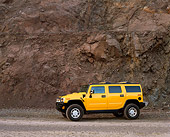 AUT 15 RK0634 01
2003 Hummer H2 Yellow 3/4 Front View By Rock Wall