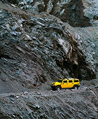 AUT 15 RK0635 07
2003 GM H2 Hummer Yellow 3/4 Side View On Rock Ledge