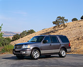 AUT 15 RK0642 02
2003 Ford Expedition XLT Gray 3/4 Front View On Pavement By Dry Grass Hill Blue Sky