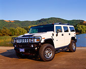 AUT 15 RK0732 05
2003 H2 Hummer White 3/4 Front View On Dirt By Water And Trees