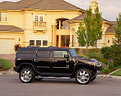 AUT 15 RK0741 05
2003 Custom H2 Hummer Black 3/4 Front View On Pavement By House