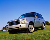 AUT 15 RK0747 03
2004 Land Rover Range Rover HSE Silver Low 3/4 Front View On Grass Blue Sky