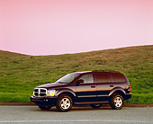 AUT 15 RK0770 01
2004 Dodge Durango Blue 3/4 Side View On Pavement Grass Hill Filtered