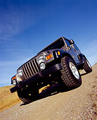 AUT 15 RK0784 02
2004 Jeep Wrangler Rubicon Light Khaki 3/4 Front View Low Angle On Dirt Road