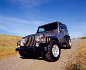 AUT 15 RK0785 02
2004 Jeep Wrangler Rubicon Light Khaki 3/4 Front View On Dirt Blue Sky