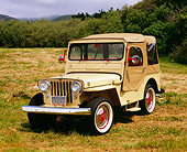AUT 15 RK0894 01
1962 Willys DJ3A Tan And Red 3/4 Front View On Grass Gray Clouds