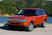 AUT 15 RK0900 01
2006 Land Rover Range Rover Sport Supercharged Orange 3/4 Front View On Pavement By Lake
