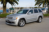 AUT 15 RK0933 01
2006 Jeep Grand Cherokee SRT8 Silver 3/4 Front View On Pavement By Harbor And  Palm Trees