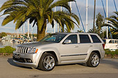 AUT 15 RK0939 01
2006 Jeep Grand Cherokee SRT8 Silver 3/4 Front View On Pavement By Palm Trees And Marina