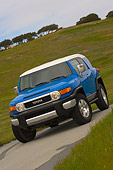 AUT 15 RK0967 01
2007 Toyota FJ Cruiser Blue And White Slanted  3/4 Front View On Pavement By Grass Hills