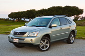 AUT 15 RK0987 01
2006 Lexus RX400 Hybrid Light Green 3/4 Front View On Pavement By Trees At Dusk