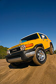 AUT 15 RK1016 01
2007 Toyota FJ Cruiser Yellow And White Low 3/4 Front View On Dirt Hill