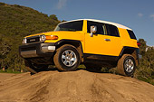 AUT 15 RK1017 01
2007 Toyota FJ Cruiser Yellow And White Low 3/4 Side View On Top Of Dirt Hill