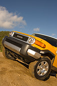 AUT 15 RK1018 01
2007 Toyota FJ Cruiser Yellow And White Low 3/4 Front View On Dirt Hill