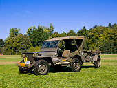 AUT 15 RK1054 01
1941 Willys MD Olive Drab Side 3/4 View On Grass Trees Background