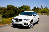 AUT 15 RK1197 01
2008 BMW X6 xDrive35i Crossover SUV White 3/4 Front View By Trees