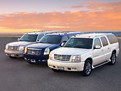AUT 15 RK1209 01
2004, 2007 & 2004 Cadillac Escalades 3/4 Front View At Dusk