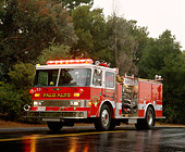 AUT 16 RK0095 02
1988 Pierce 1500 GPM Pumper Front 3/4 View On Wet Road By Trees
