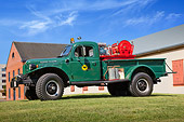 AUT 16 RK0192 01
1962 Dodge Power Wagon Fire Truck Green Profile View On Grass By Brick Building