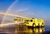 AUT 16 RK0028 29
1997 Oshkosh T-1000 #8 And 1998 Teledyne P-23 #9 Crash Truck Yellow 3/4 Front View Spraying Water