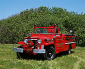 AUT 16 RK0039 02
1953 Willys Fire Truck 3/4 Front View On Grass Blue Sky