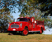 AUT 16 RK0044 05
1960 International Fire Engine Truck 3/4 Front View On Grass By Trees