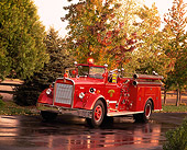 AUT 16 RK0078 10
1952 K.W. Van Pelt Fire Truck 3/4 Front View On Wet Pavement By Trees