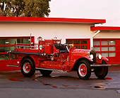AUT 16 RK0100 07
1921 Stutz Fire Truck 3/4 Front View On Wet Pavement By Building