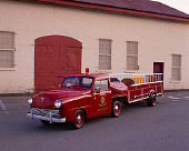 AUT 16 RK0132 01
1949 Crosley Ladder Firetruck Red 3/4 Front View By Garage