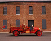 AUT 16 RK0136 04
1909 Kissel Hose And Chemical Firetruck Red Profile View On Pavement By Brick Building