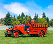 AUT 16 RK0146 01
1930 Ford Model A Fire Truck Red 3/4 Front View By Trees Blue Sky