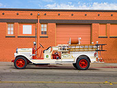 AUT 16 RK0154 01
1929 American LaFrance Triple Combination Fire Truck White Profile View By Building