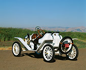 AUT 17 RK0024 01
1914 Ford Model T Speedster White 3/4 Rear View On Pavement Green Fields