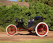 AUT 17 RK0034 08
1903 Duryea Three-Wheeler Green Front 3/4 View On Dirt By Bushes