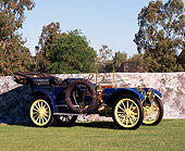 AUT 17 RK0049 03
1910 Oldsmobile LTD Touring Car 3/4 Front View on Grass By Stone Wall Blue Sky