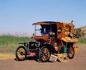 AUT 17 RK0053 17
1914 Ford Model T Delivery Truck 3/4 Front View On Road Green Field Background
