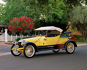 AUT 17 RK0091 04
1913 Star Gentleman's Roadster Yellow 3/4 Front View By House Trees Fence