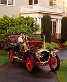 AUT 17 RK0106 07
1907 Thomas Flyer With Driver Burgundy 3/4 Front View On Driveway By House