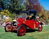 AUT 17 RK0137 01
1911 Ford Model T Torpedo Red And Black 3/4 Side View On Grass By Trees And Bushes