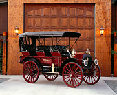 AUT 17 RK0149 03
1912 IHC Auto Wagon Maroon And Black 3/4 Front View On Pavement By Garage Door