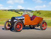 AUT 18 RK0784 01
1926 Ford Model T Speedster Natural Wood 3/4 Side View On Pavement By Grassy Hills