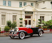 AUT 19 RK0306 01
1930's Duesenberg Convertible Red And Black Side 3/4 View On Pavement By Buidling