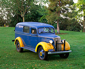 AUT 19 RK0422 02
1937 Chevrolet 1 1/2 Ton National Guard Ambulance Blue And Yellow 3/4 Front View On Grass Trees